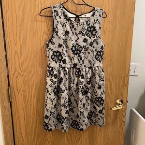 L black and white sleeveless dress with floral design.